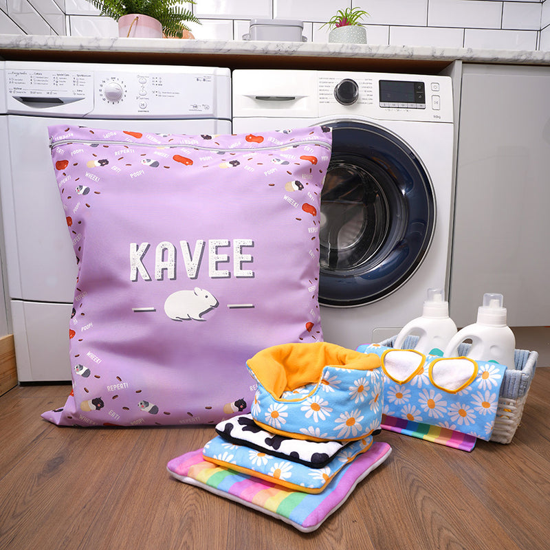 Kavee purple laundry bag in front of washing machine