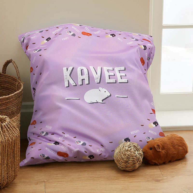 kavee laundry bag in room on wooden floor with wicker toys and baskets