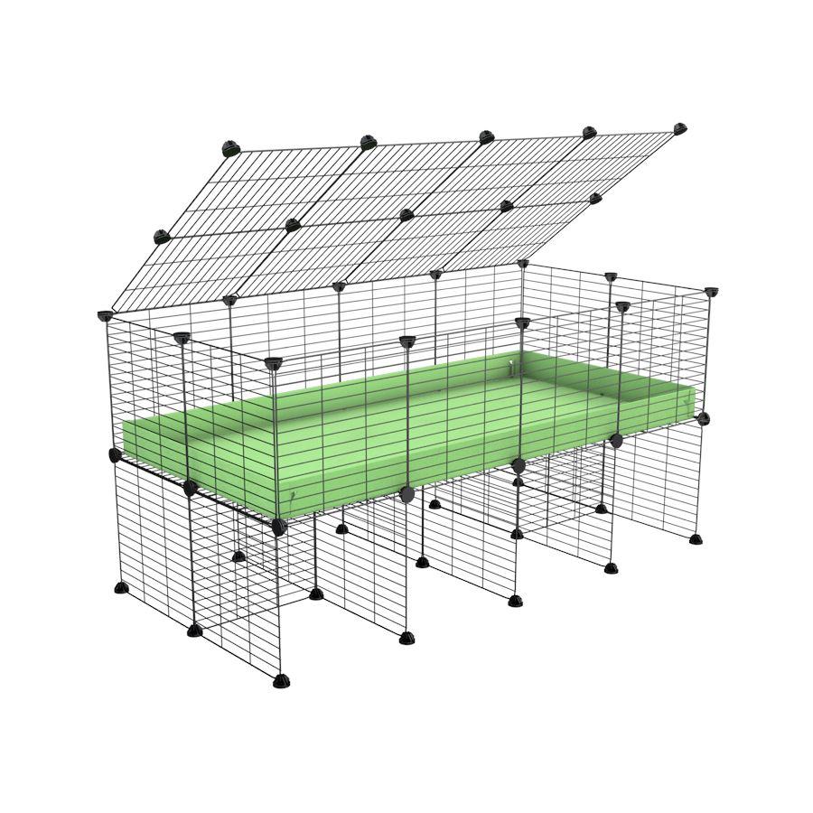 a 4x2 C&C cage for guinea pigs with a stand and a top green pastel pistachio plastic safe grids by kavee