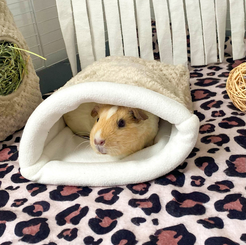 a white guinea pig inside  kavee taupe sleep sack on top of leopard liner